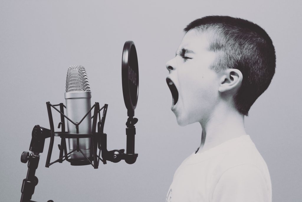 Boy shouting in microphone_black/white photo